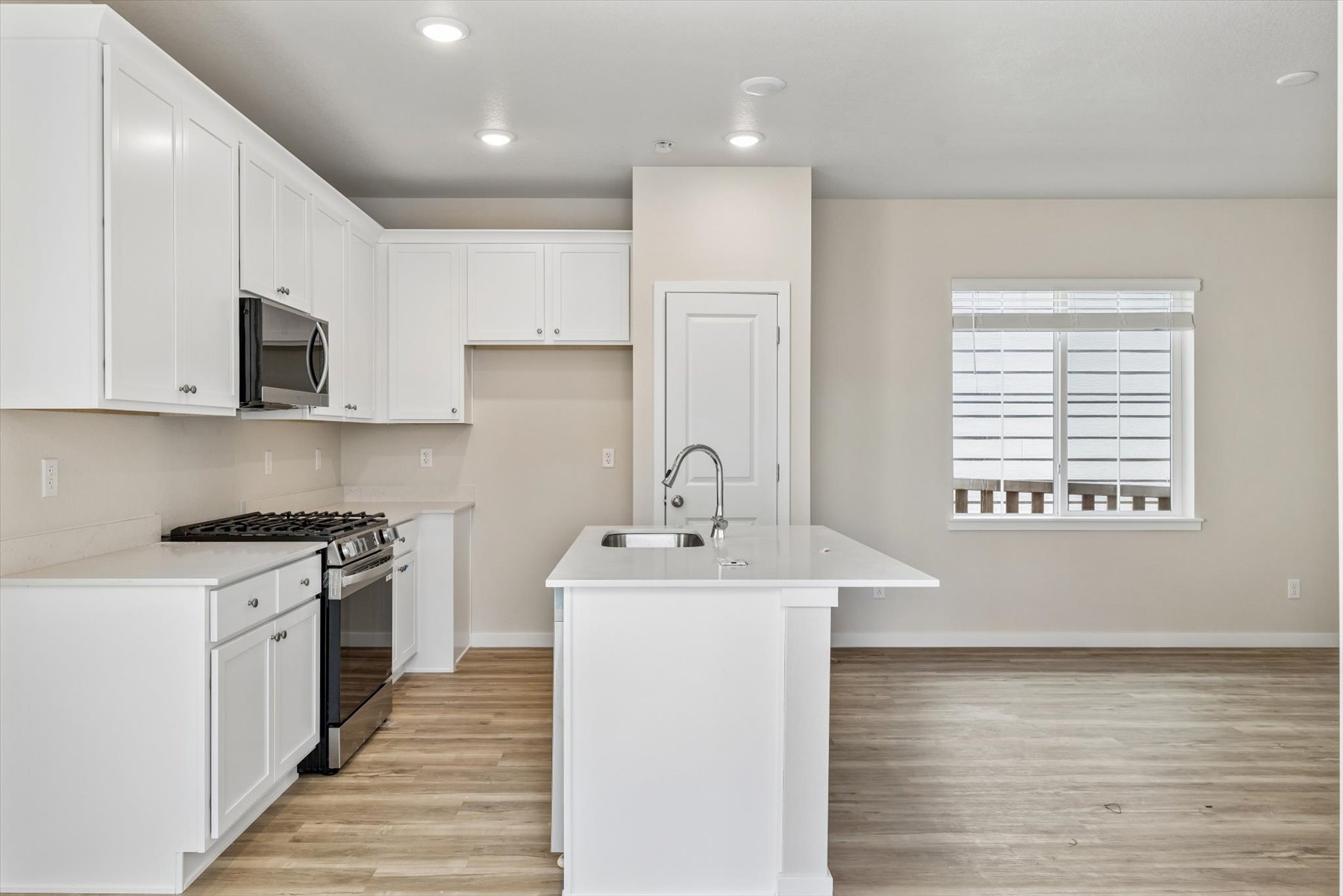 A kitchen with white cabinets.