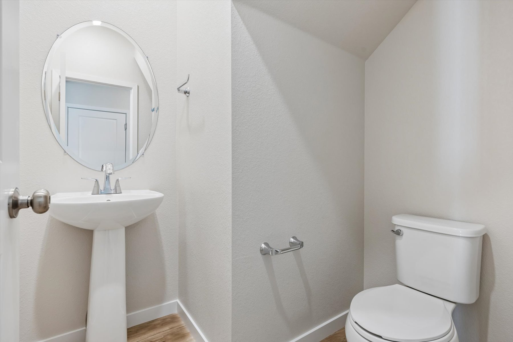 A bathroom with a sink and toilet.