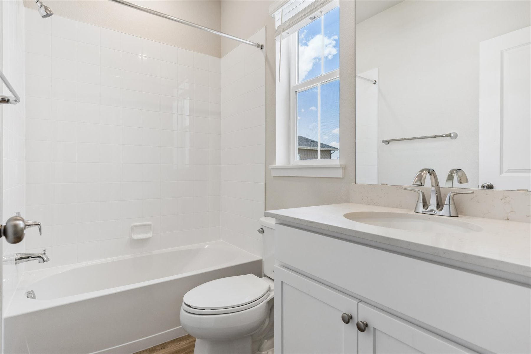 A bathroom with a tub sink and toilet.