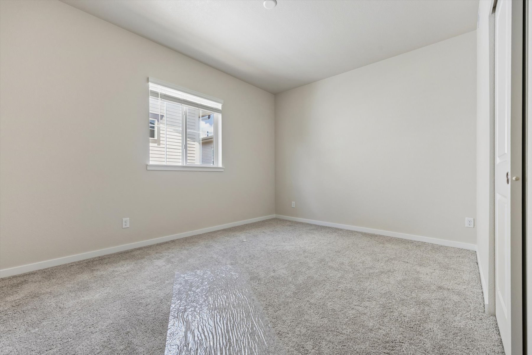 A room with a carpet and a rug.