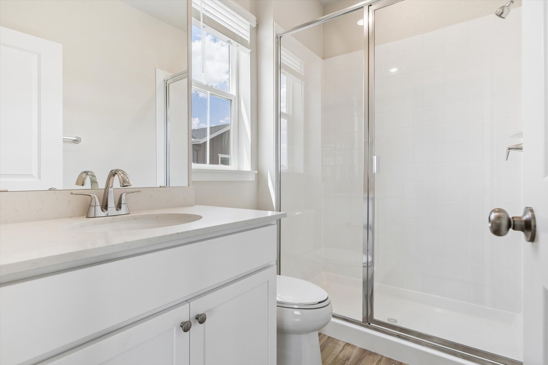 A bathroom with a glass shower.