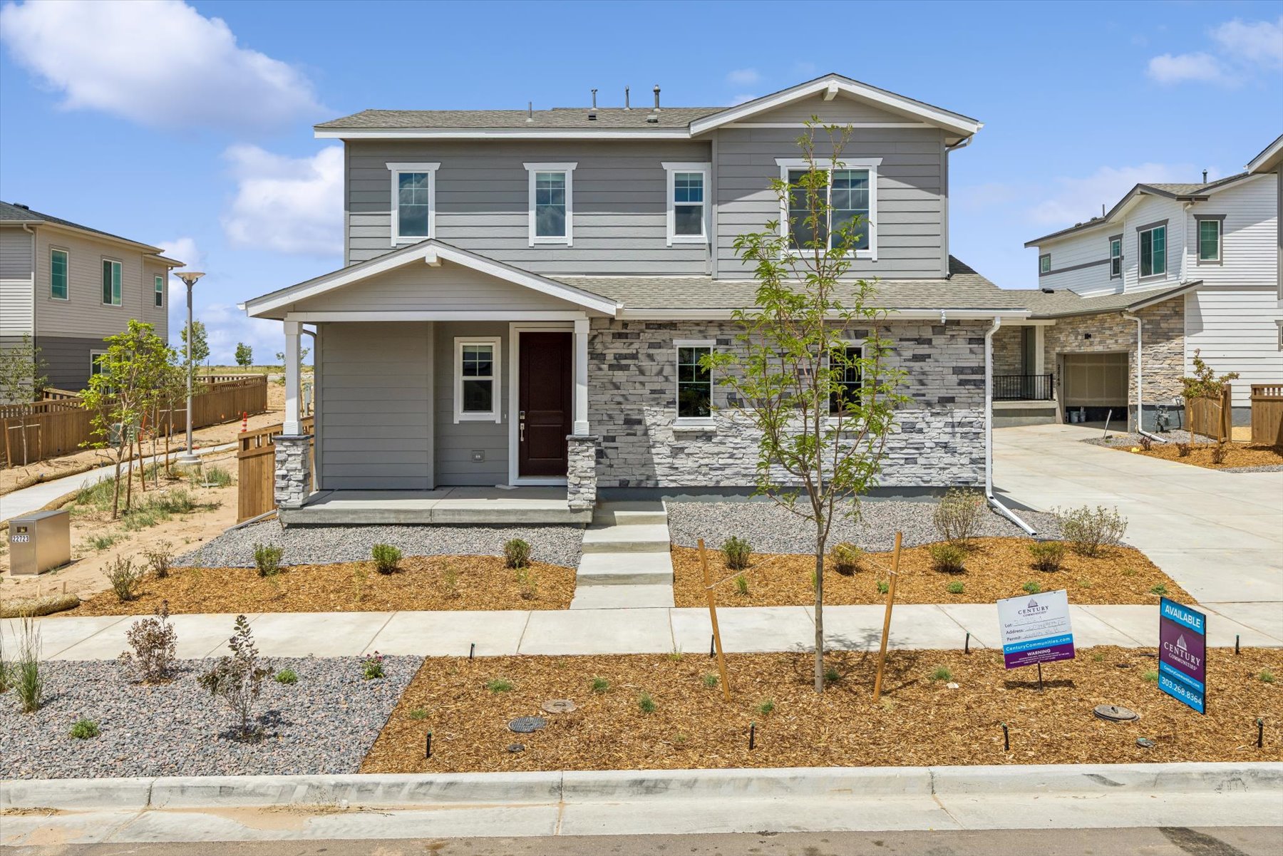 A house with a tree in the front.