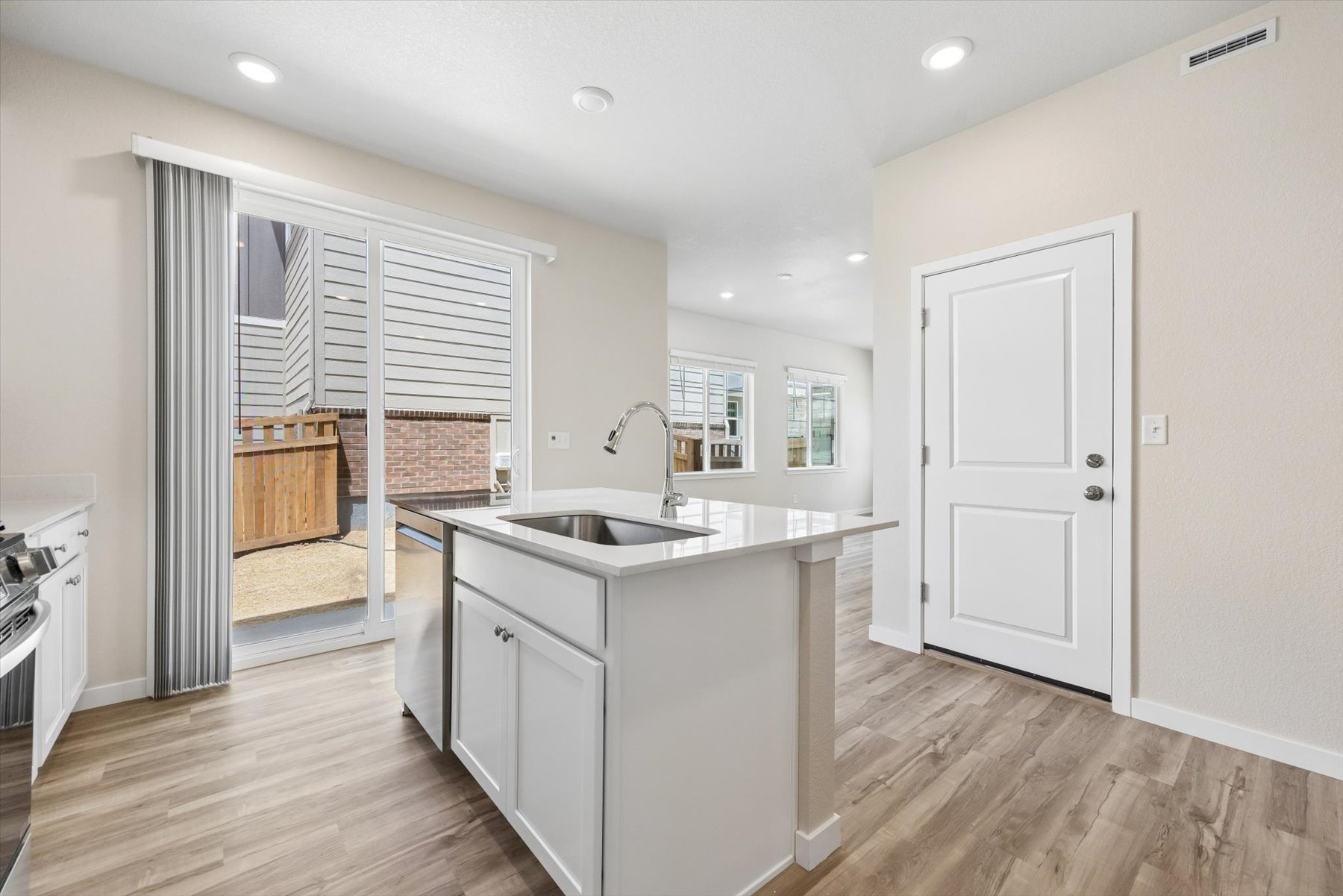 A kitchen with white cabinets.
