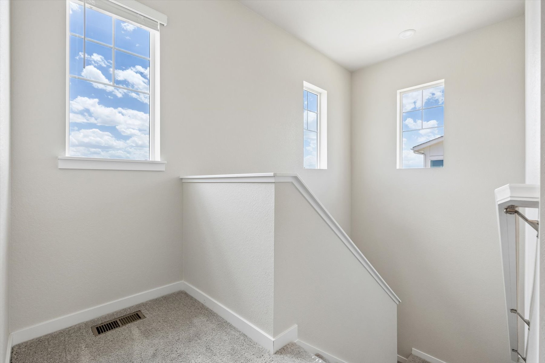 A room with a shower and a window.