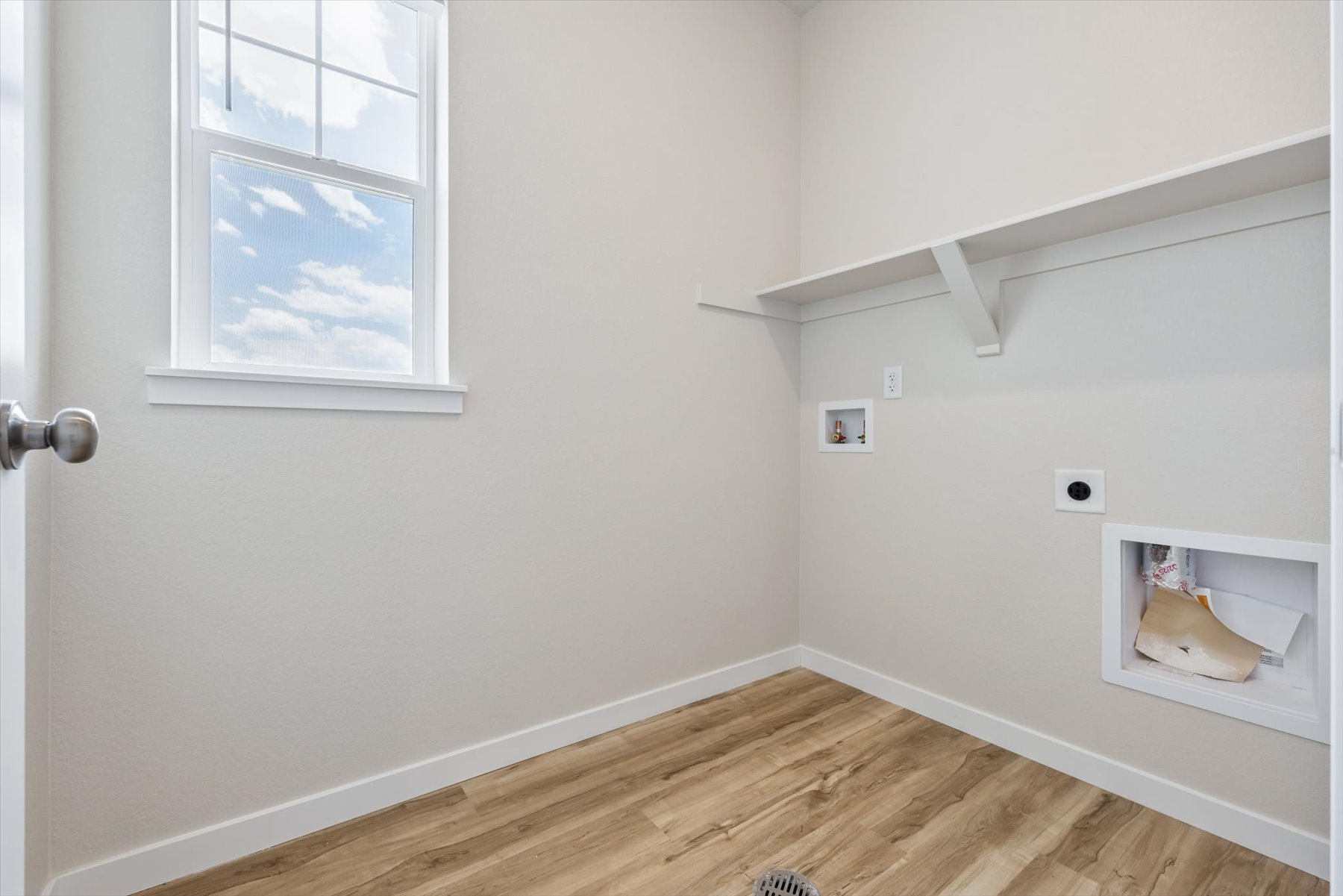 A room with a wood floor and a window.