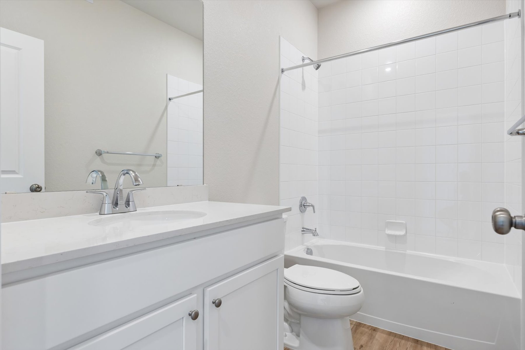 A bathroom with a tub toilet and sink.