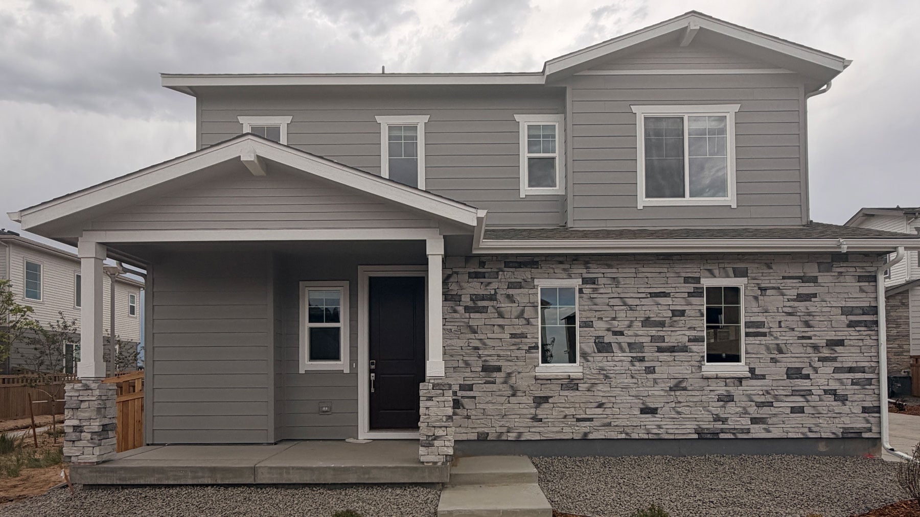 A grey house with a garage.