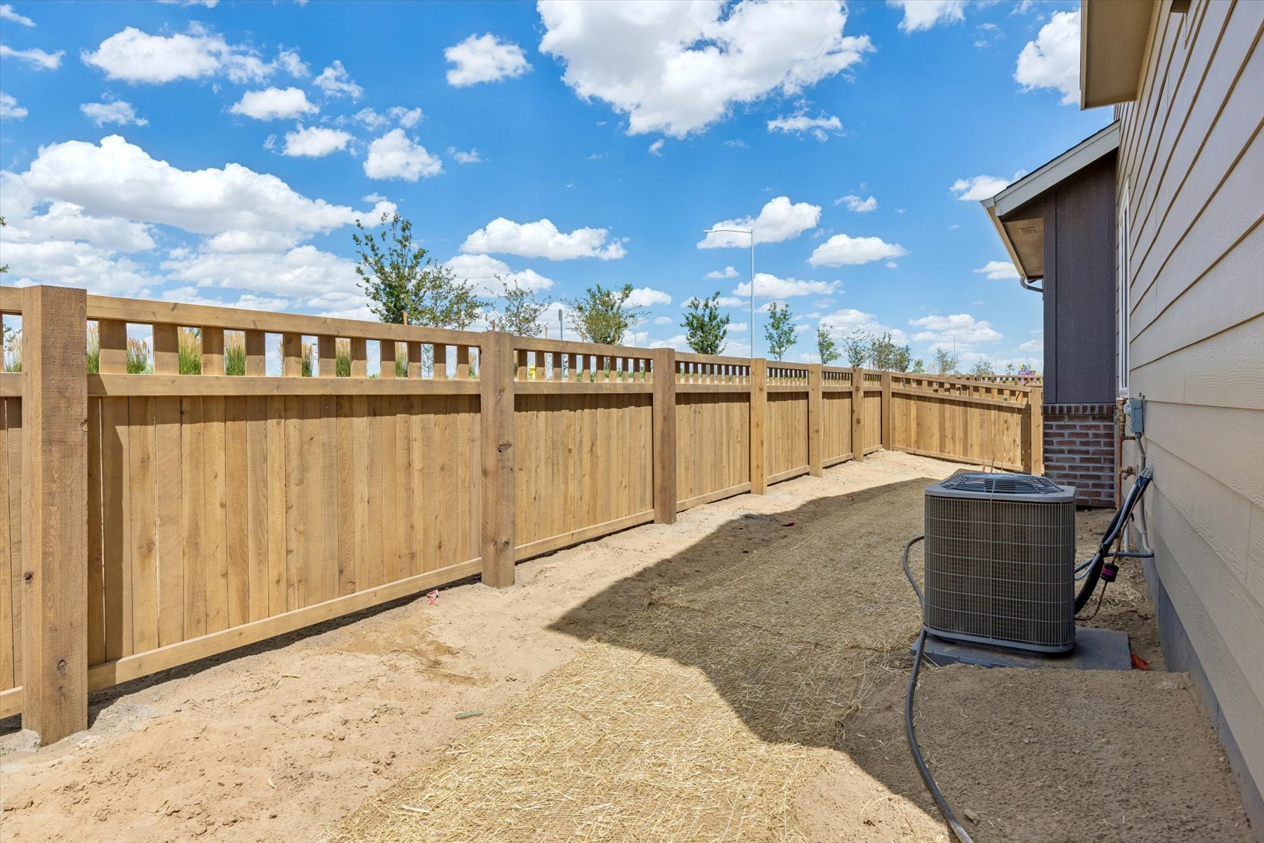 A fenced in area with a cart and a wood fence.
