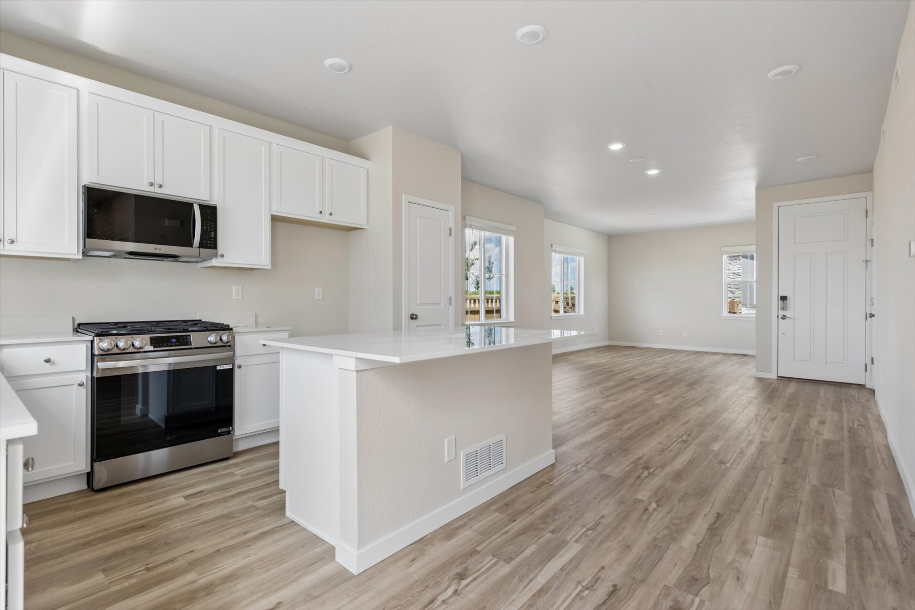 A kitchen with white cabinets.