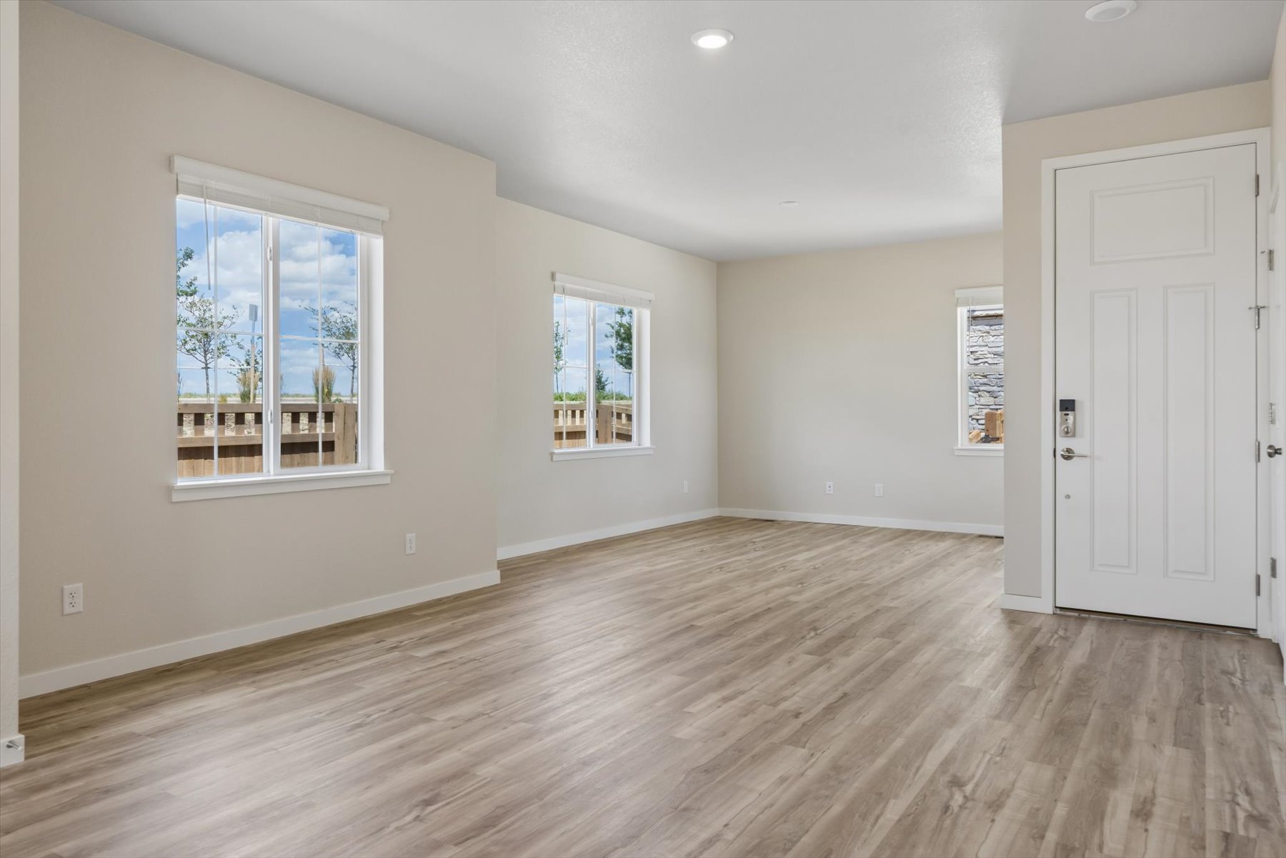 A room with a wood floor and windows.