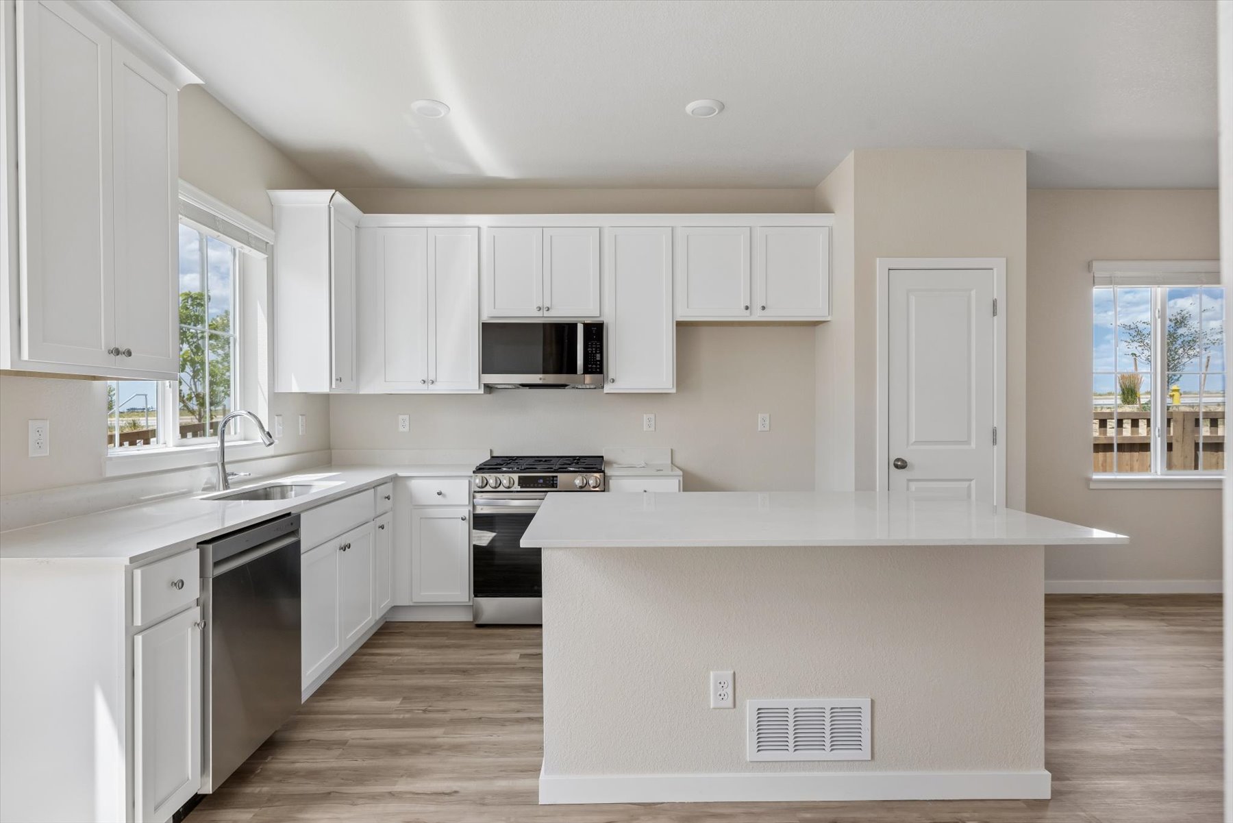 A kitchen with white cabinets.