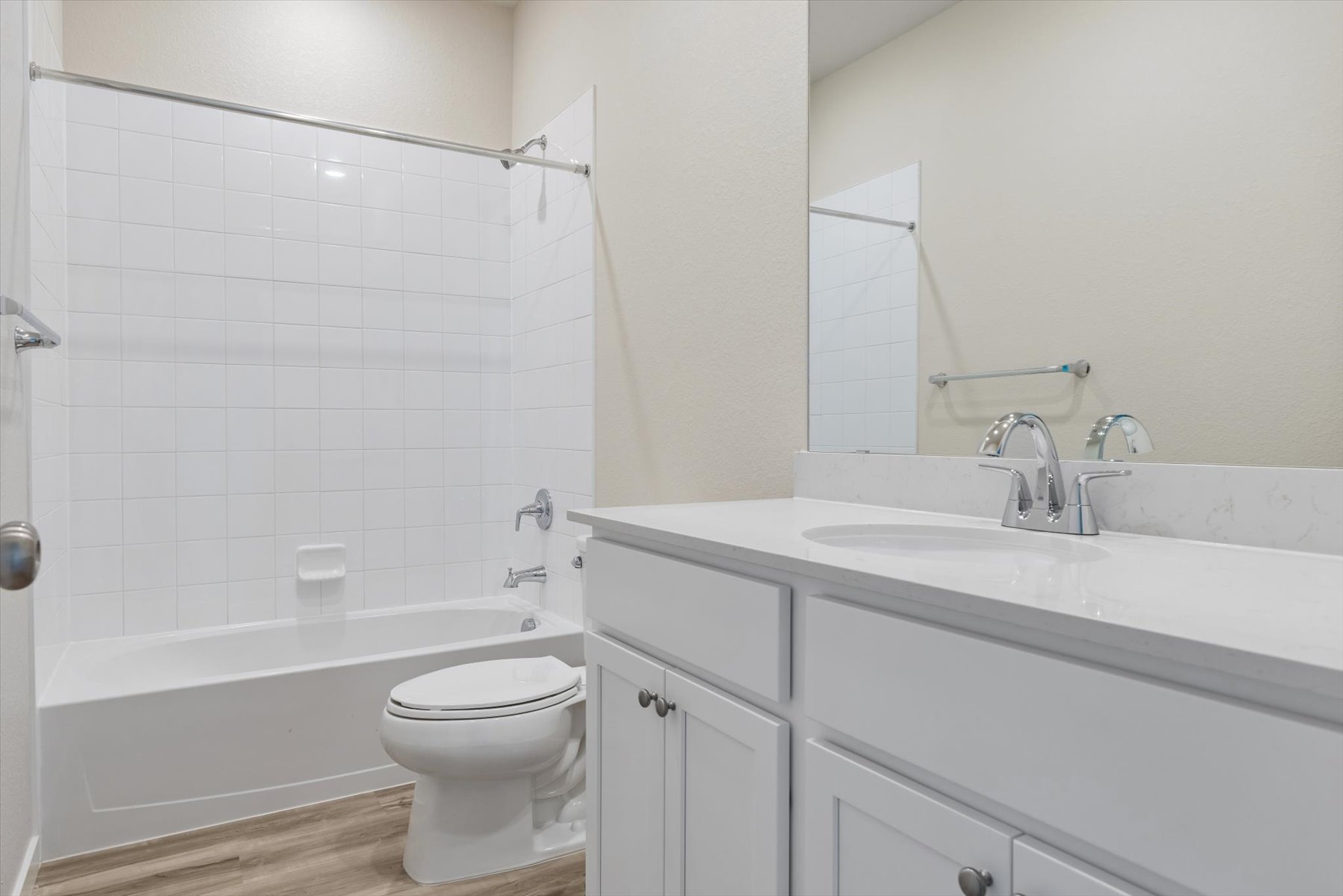 A bathroom with a tub toilet and sink.