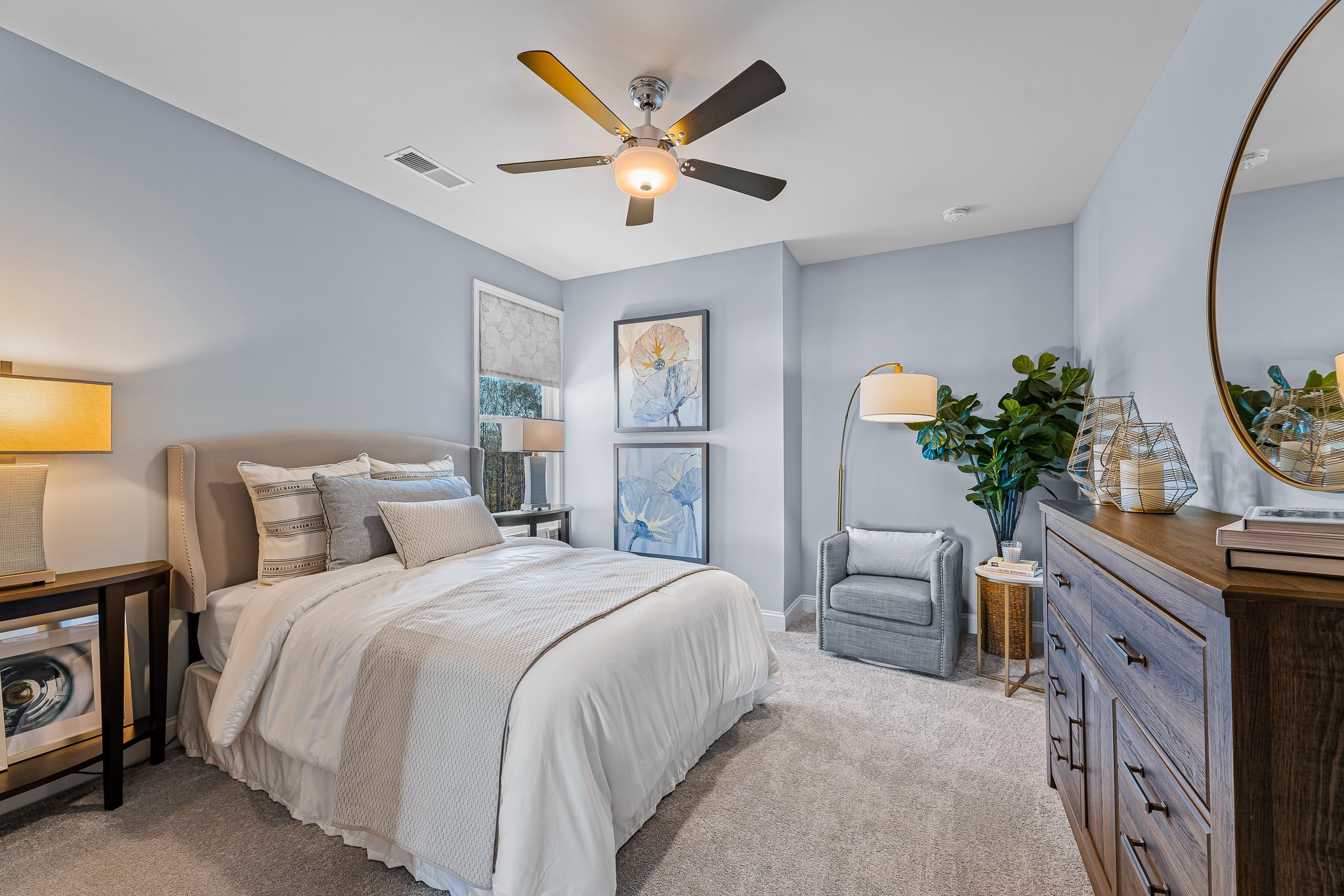 A bedroom with a bed and a fan.