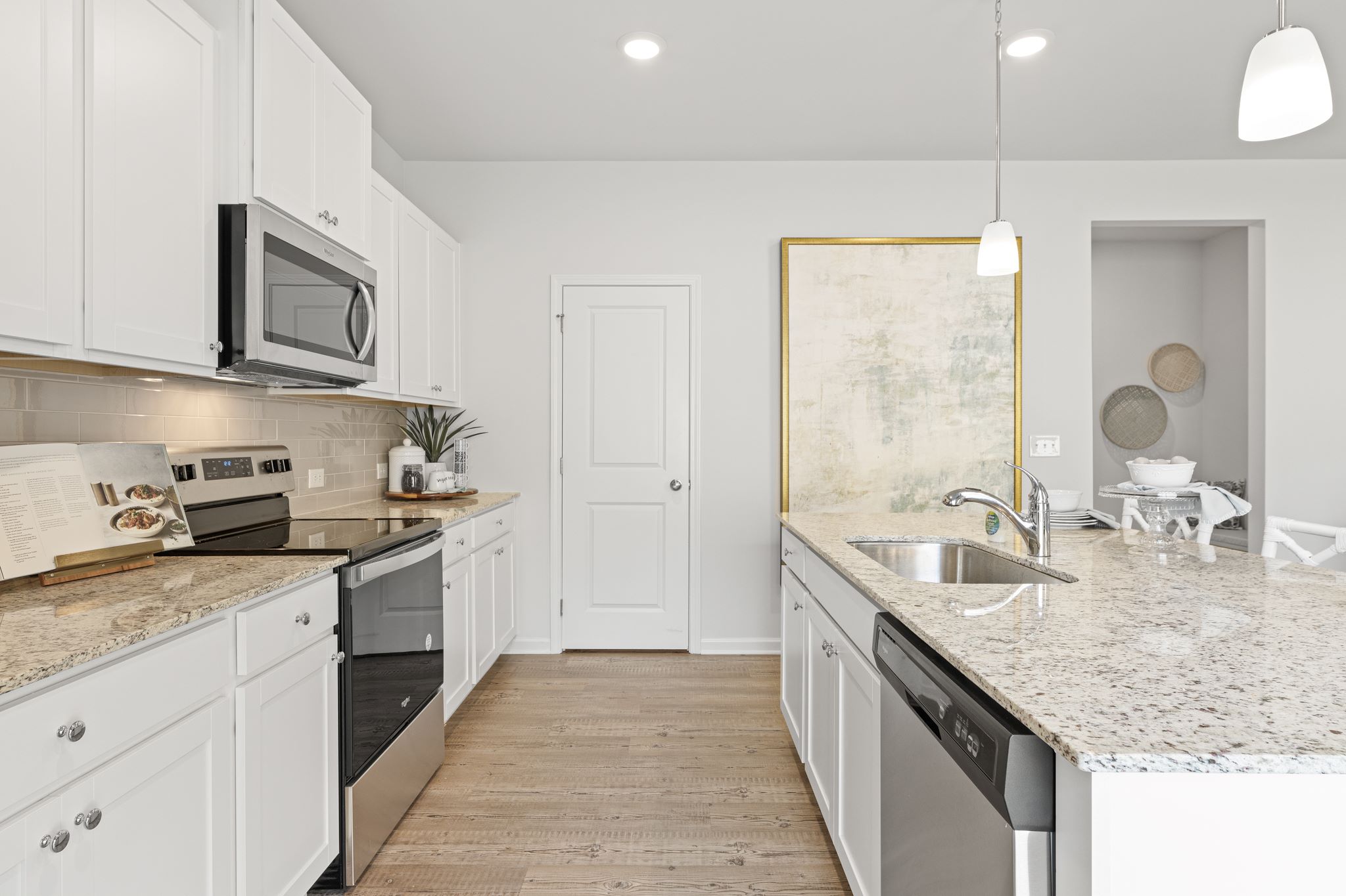 A kitchen with white cabinets.