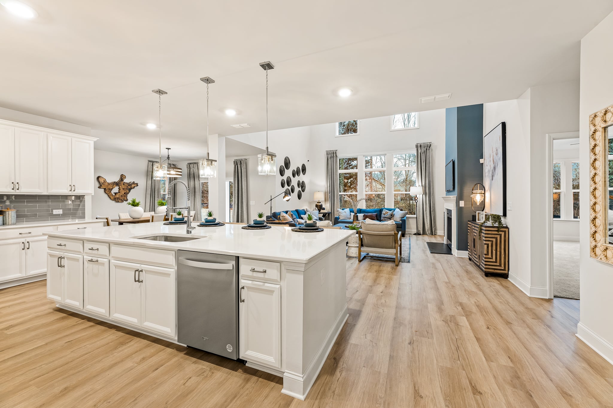 A kitchen with white cabinets.