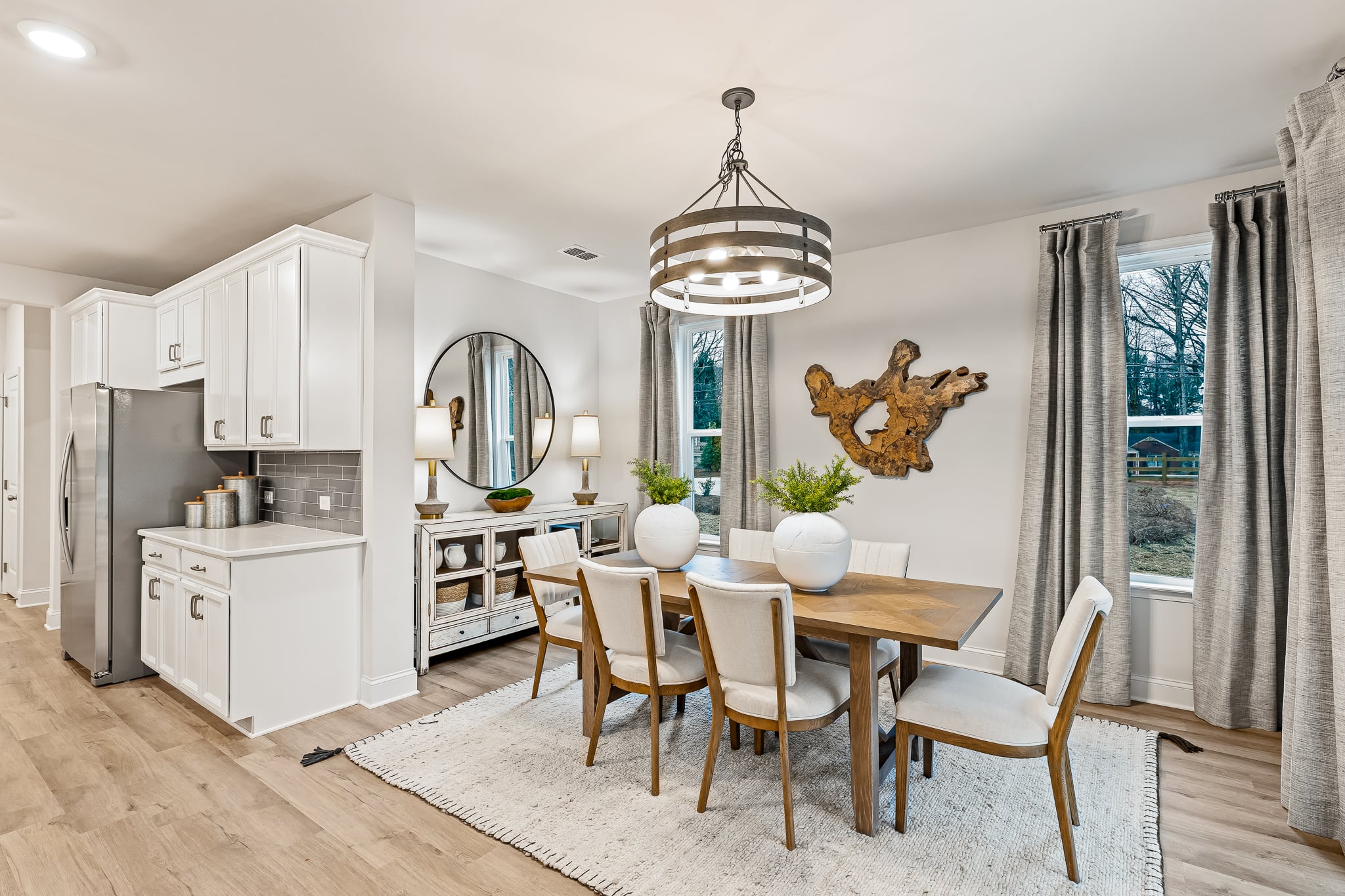 A dining room with a chandelier and a table.