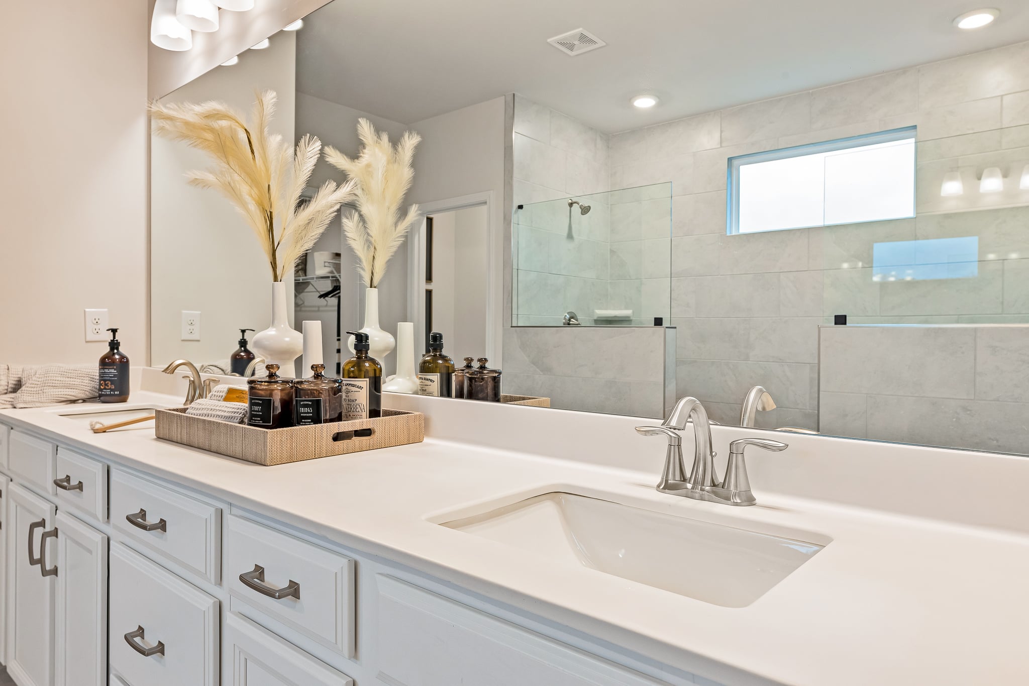 A bathroom with a tub sink and a mirror.