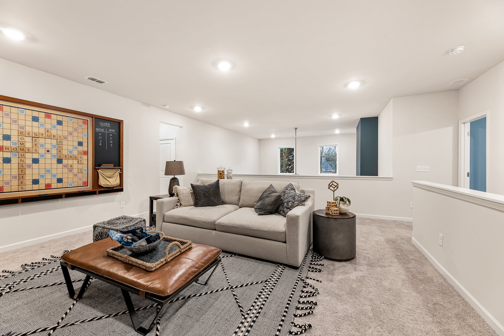 A large living room with a large rug and a couch.