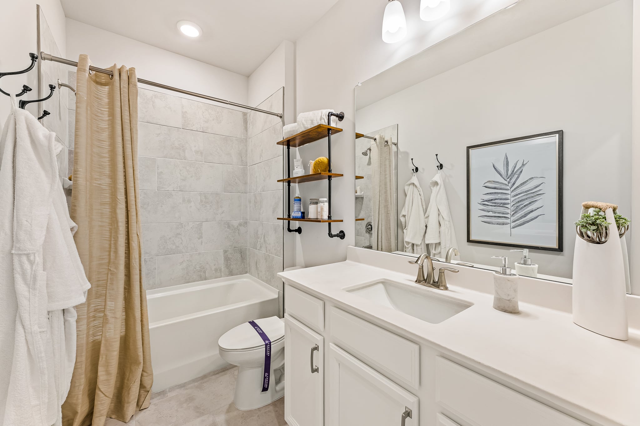 A bathroom with a tub sink and toilet.