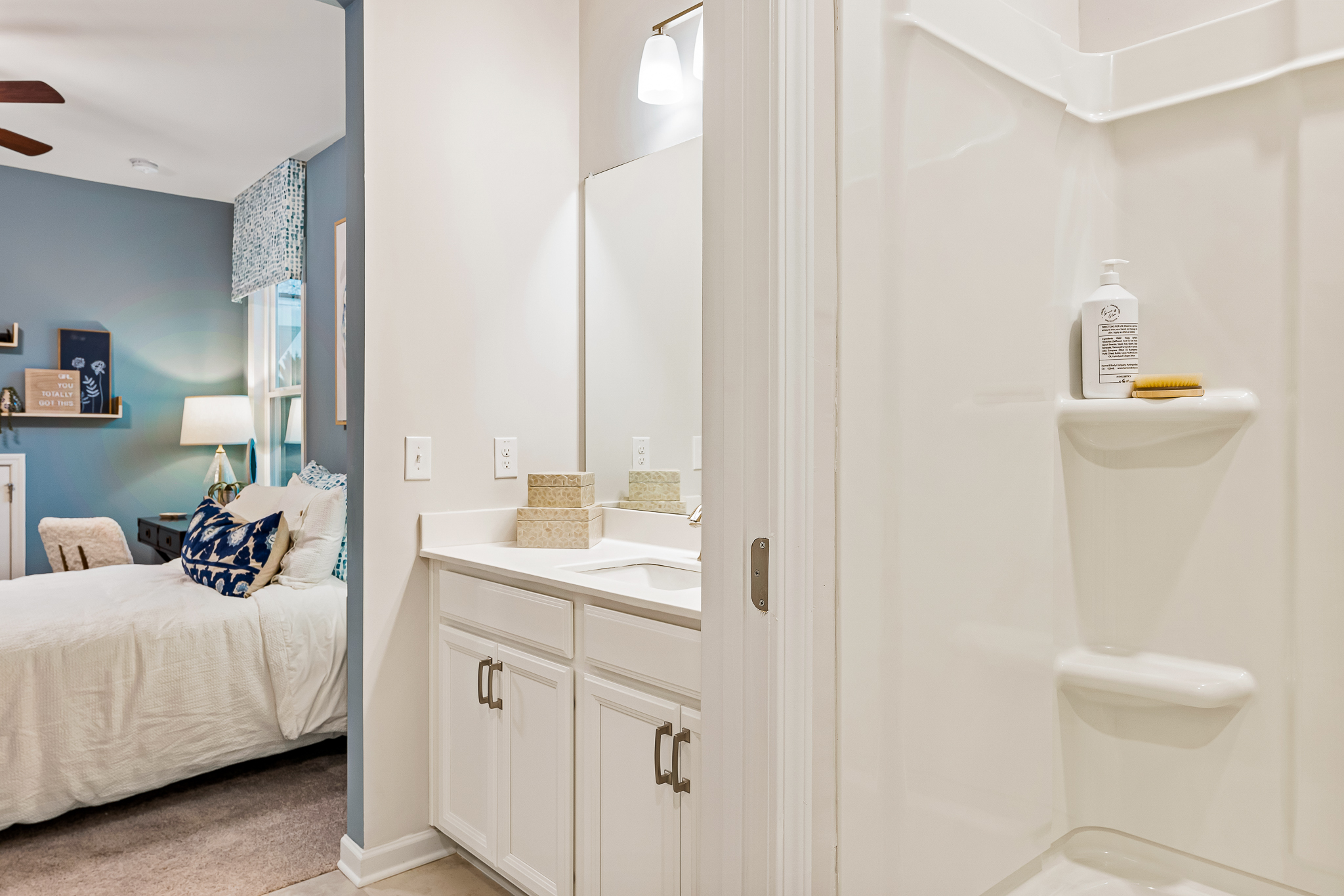 A bathroom with a bed and a sink.