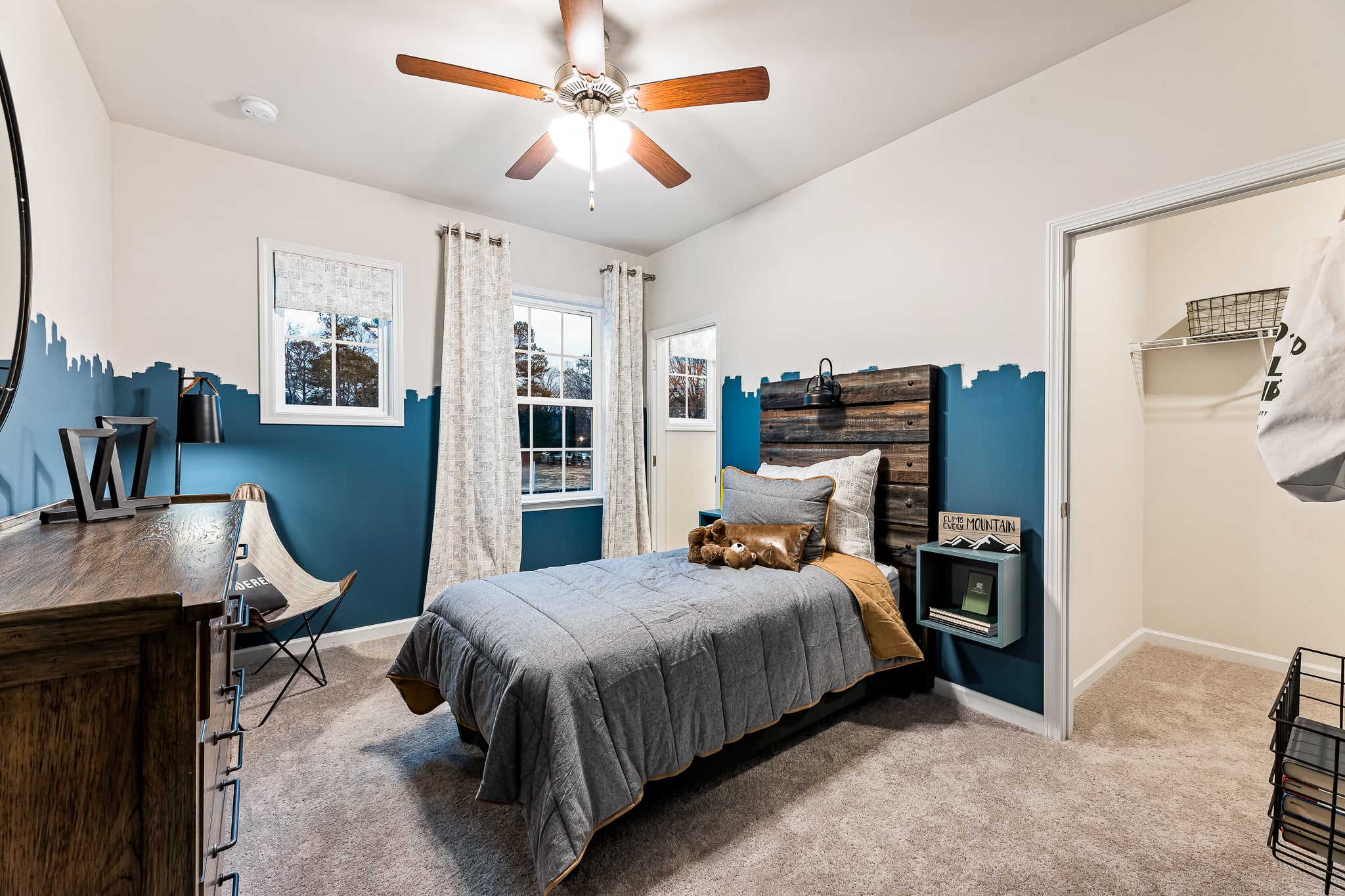 A bedroom with a bed and a fan.