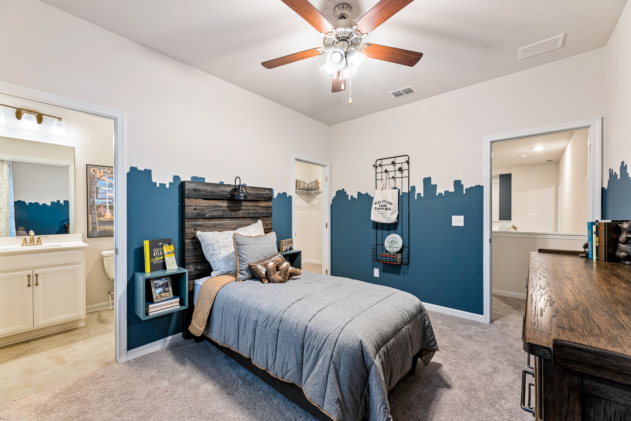 A bedroom with a bed and a fan.