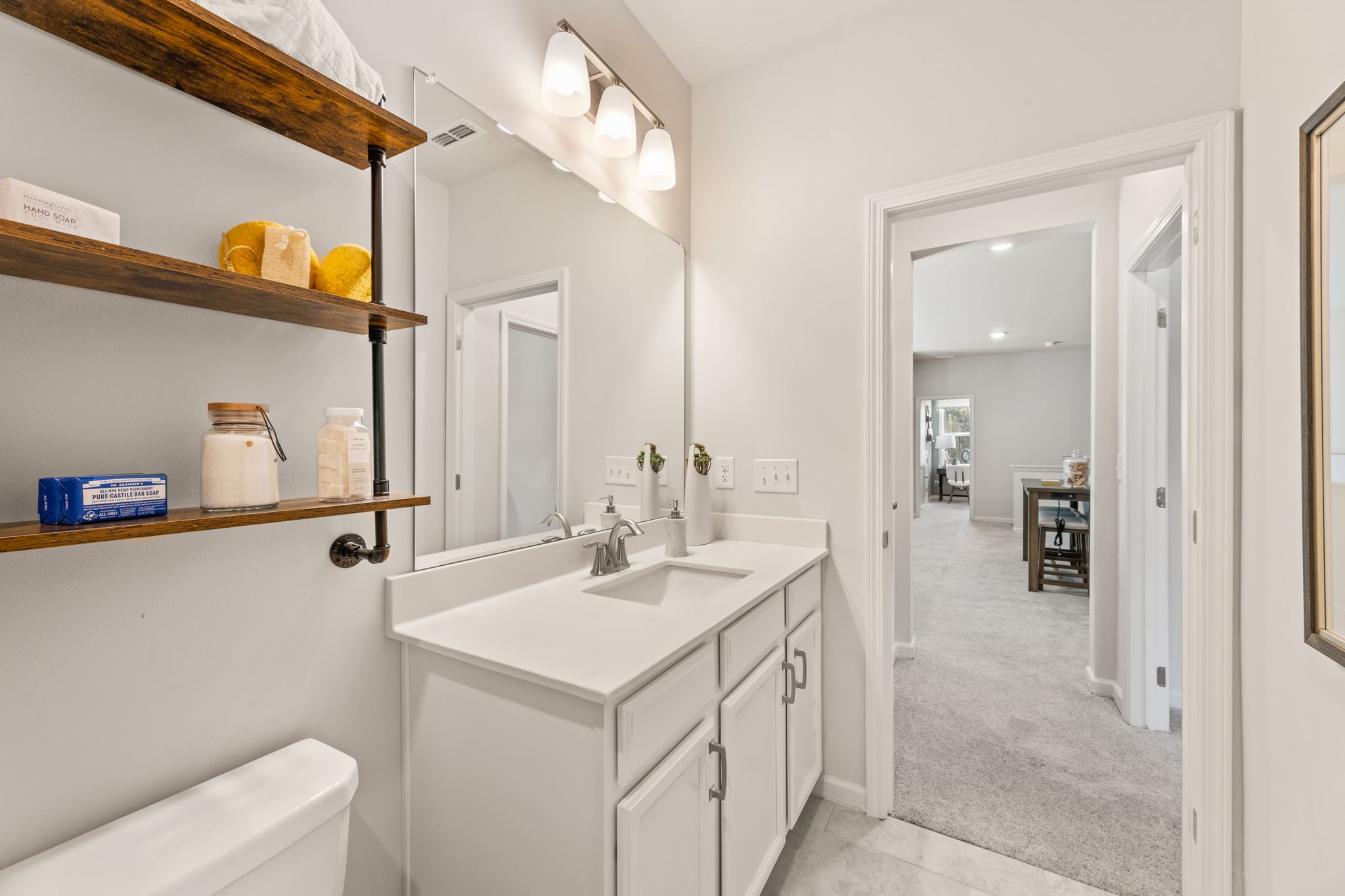 A bathroom with a sink and shelves.