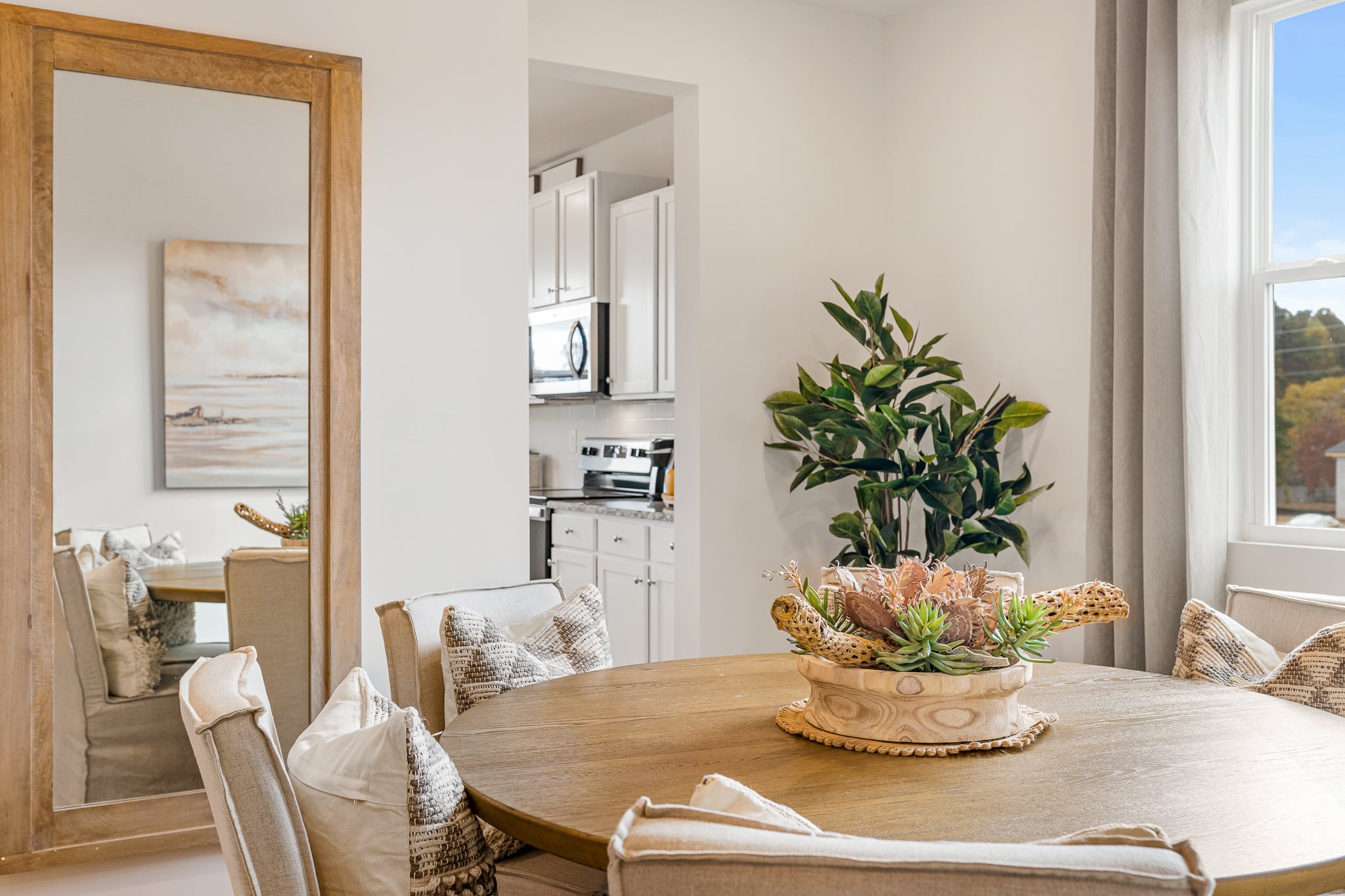 A living room with a table and chairs.