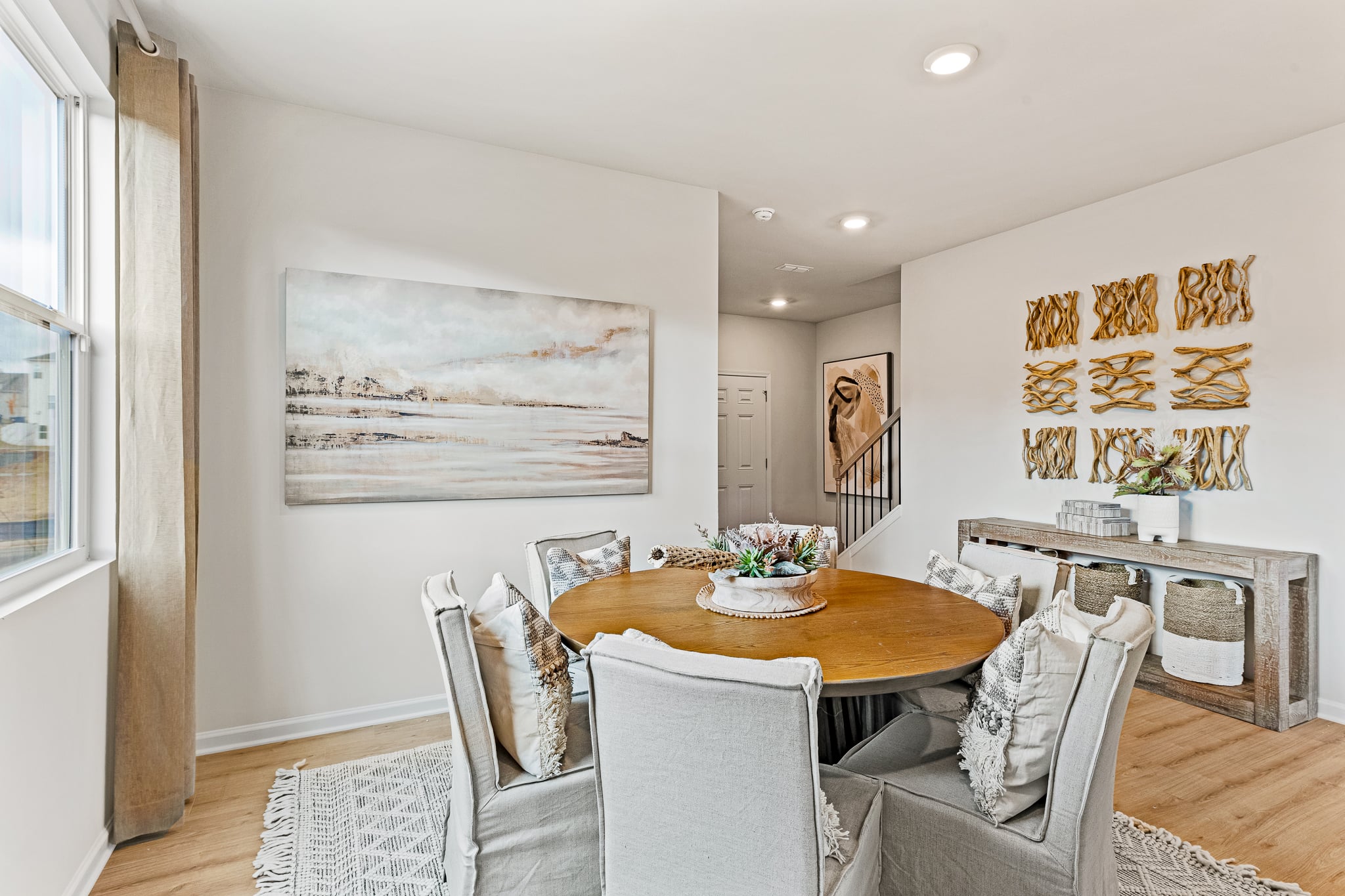 A living room with a table and chairs.