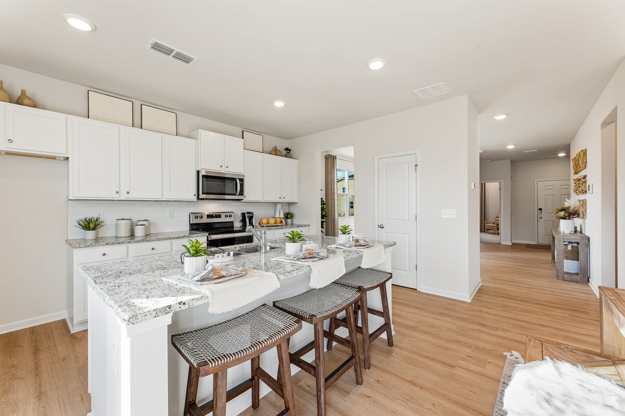 A kitchen with white cabinets.