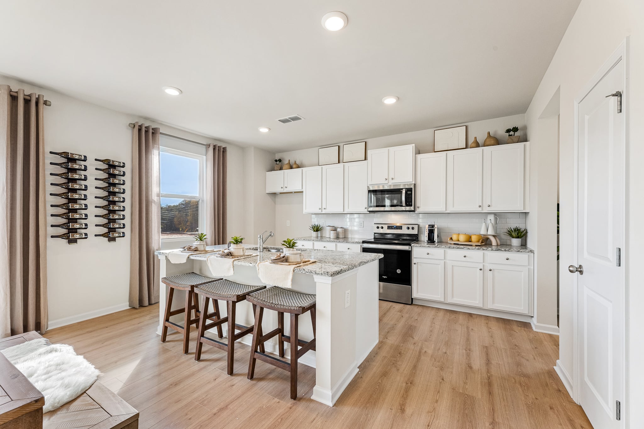A kitchen with a table and chairs.