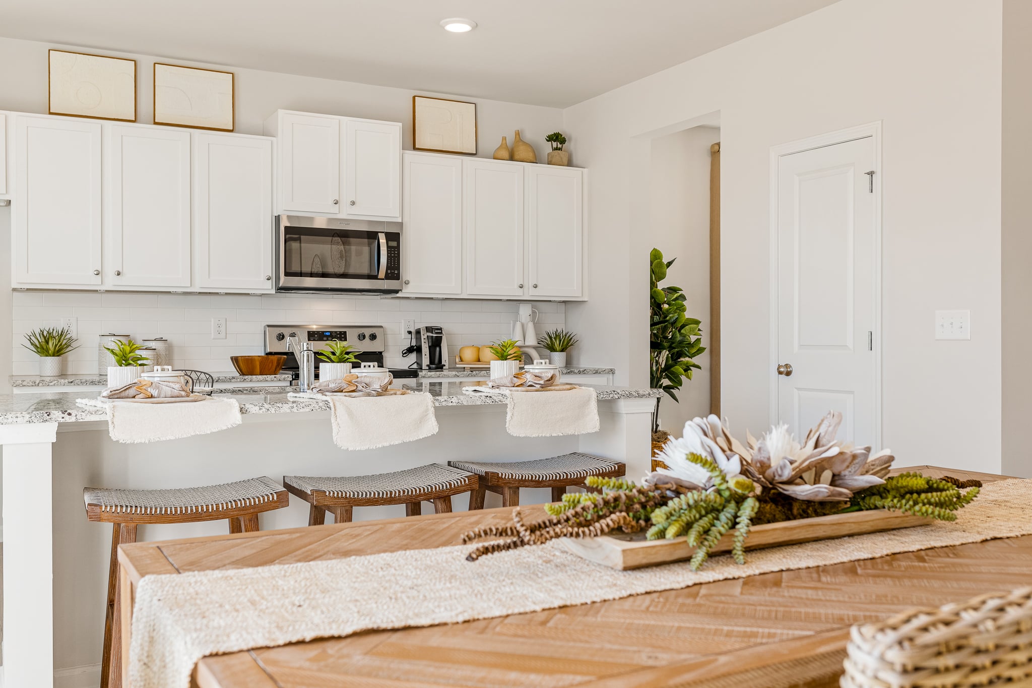 A kitchen with white cabinets.