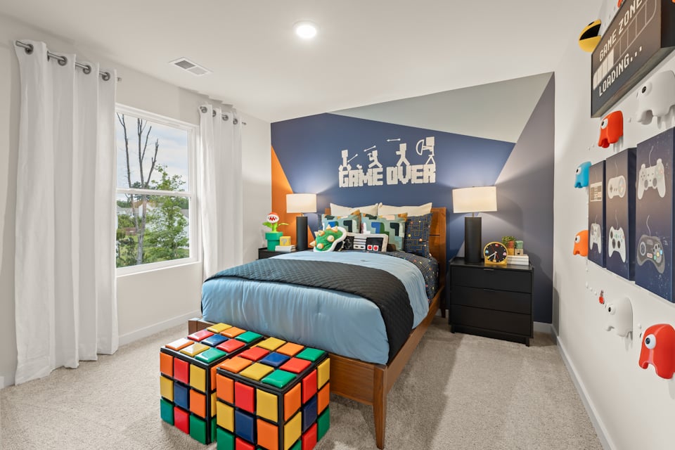 A bedroom with a bed and a desk.