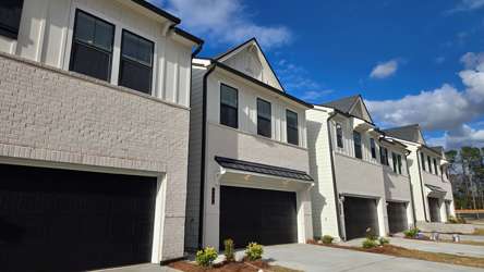 A white building with a garage.