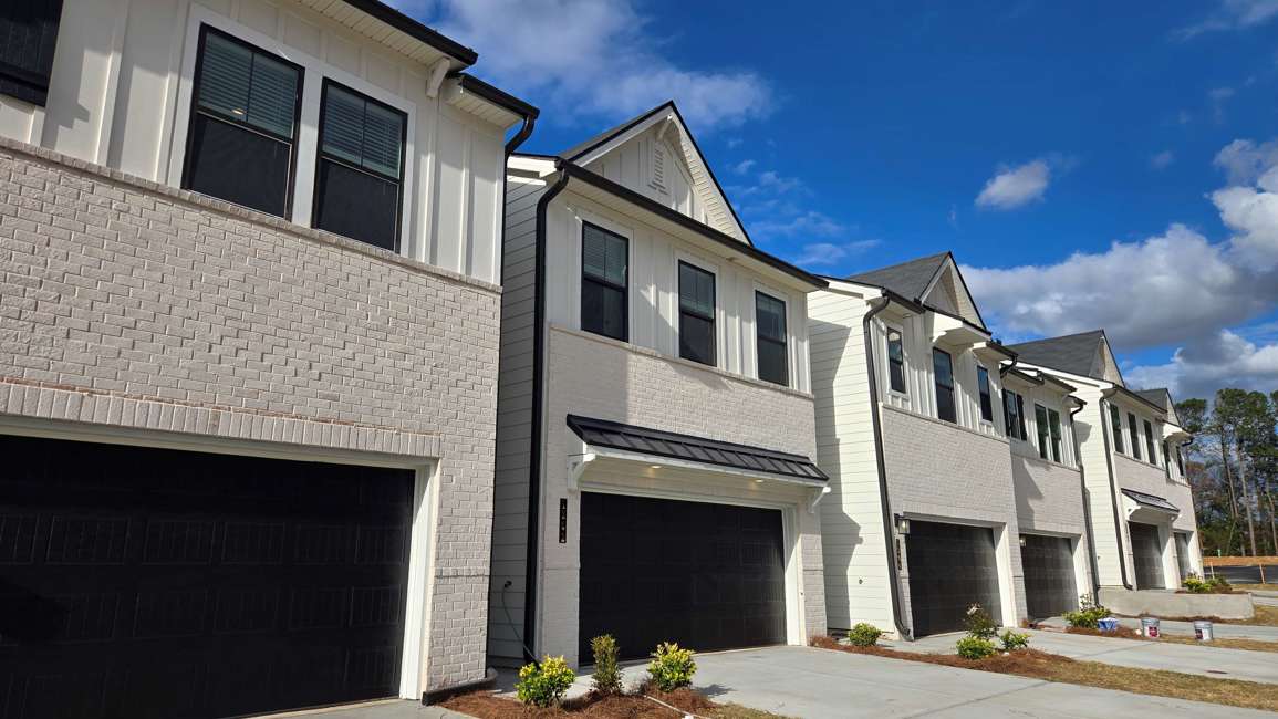 A white building with a garage.
