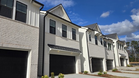 A white house with a garage.