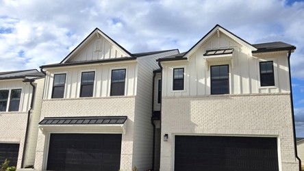 A grey house with a garage.