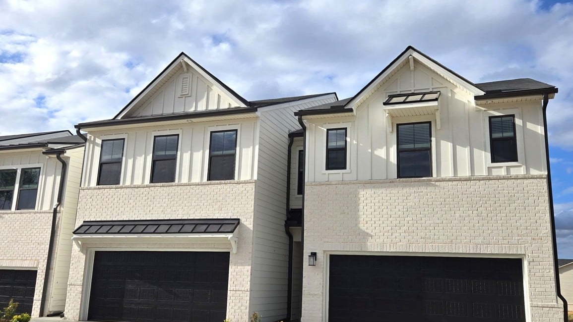 A grey house with a garage.