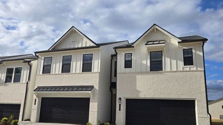 A grey house with a garage.