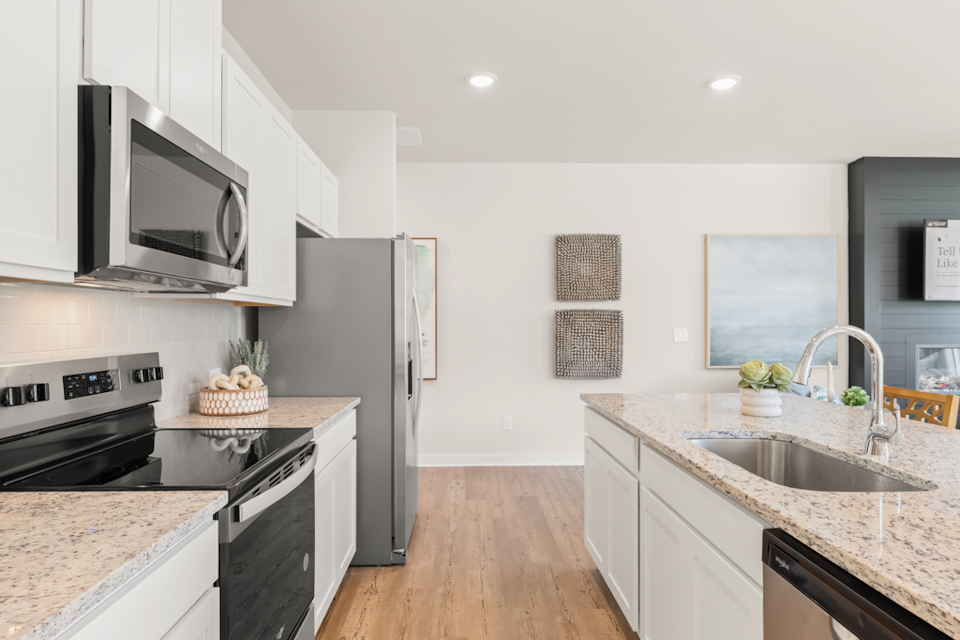 A kitchen with white cabinets.