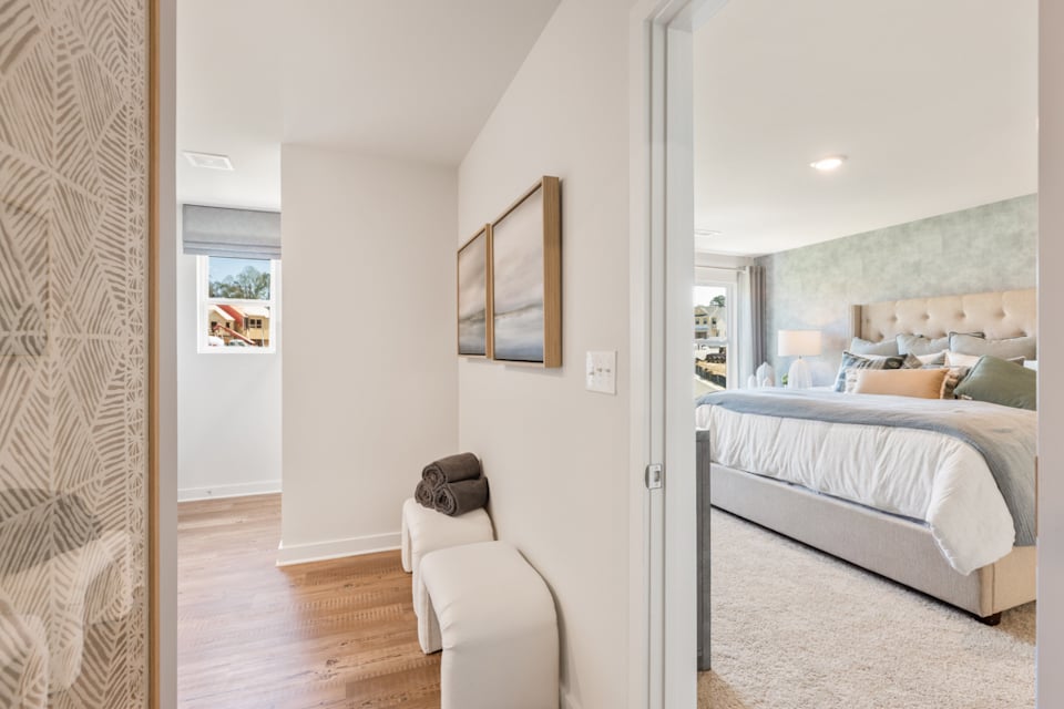 A bedroom with a bed and a chair.