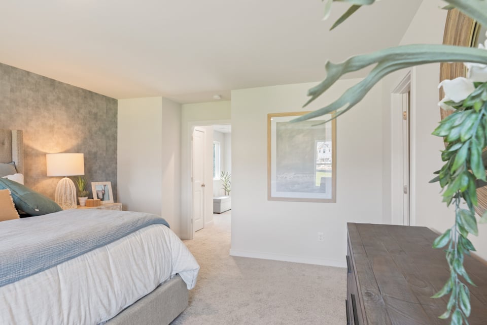 A bedroom with a bed and a desk.