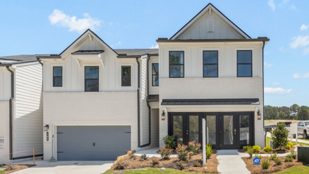A white house with a garage.