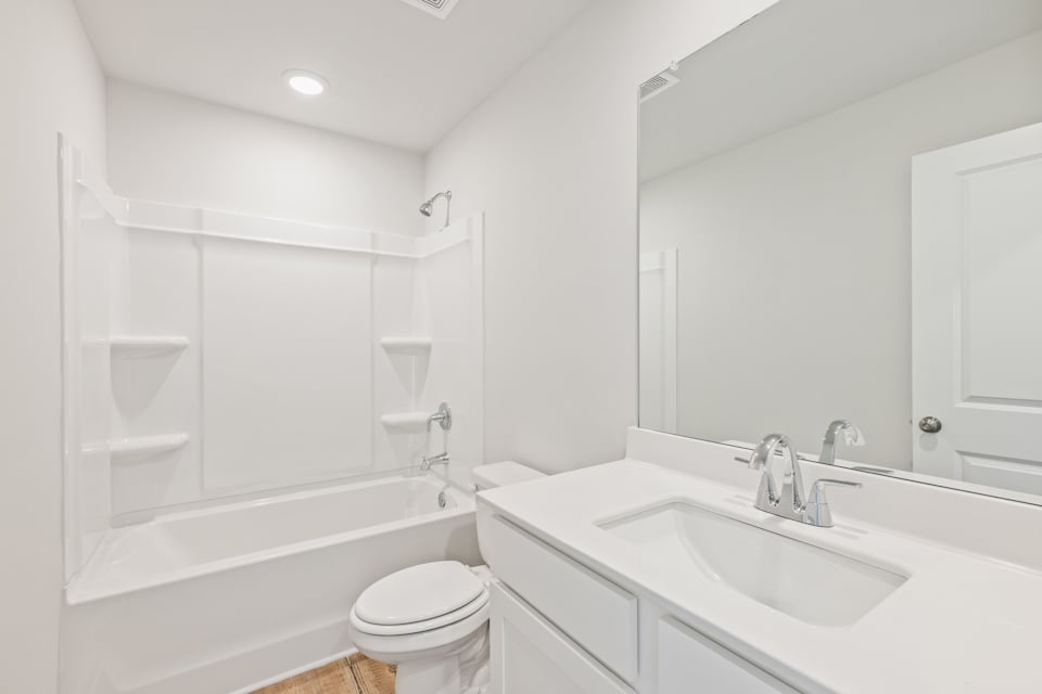 A bathroom with a tub sink and toilet.