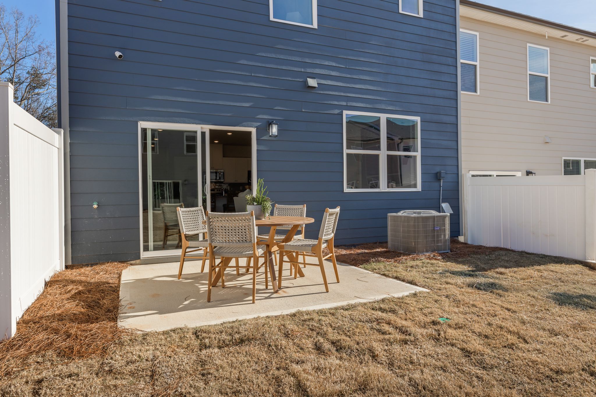A table and chairs outside a house.