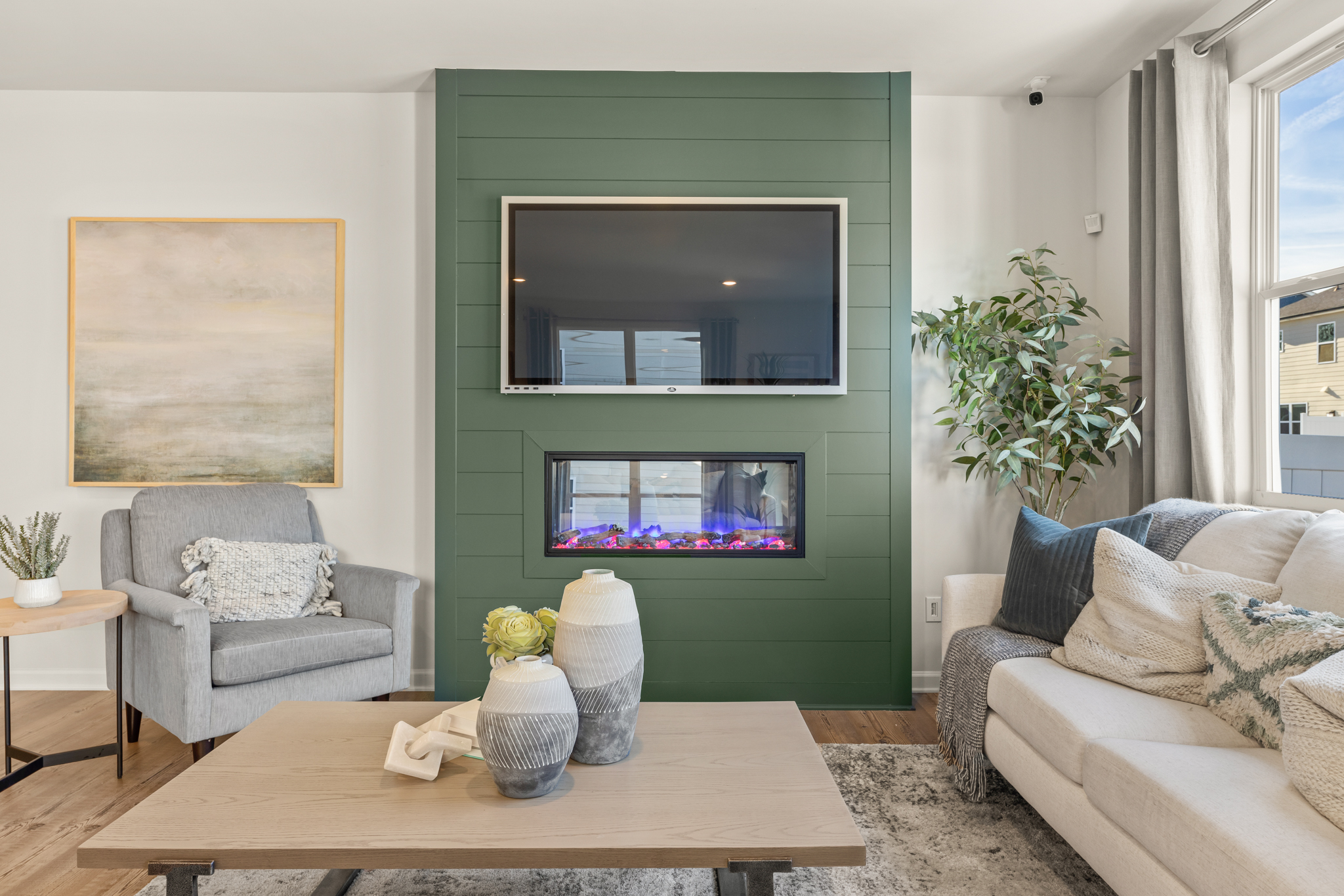 A living room with a green wall.