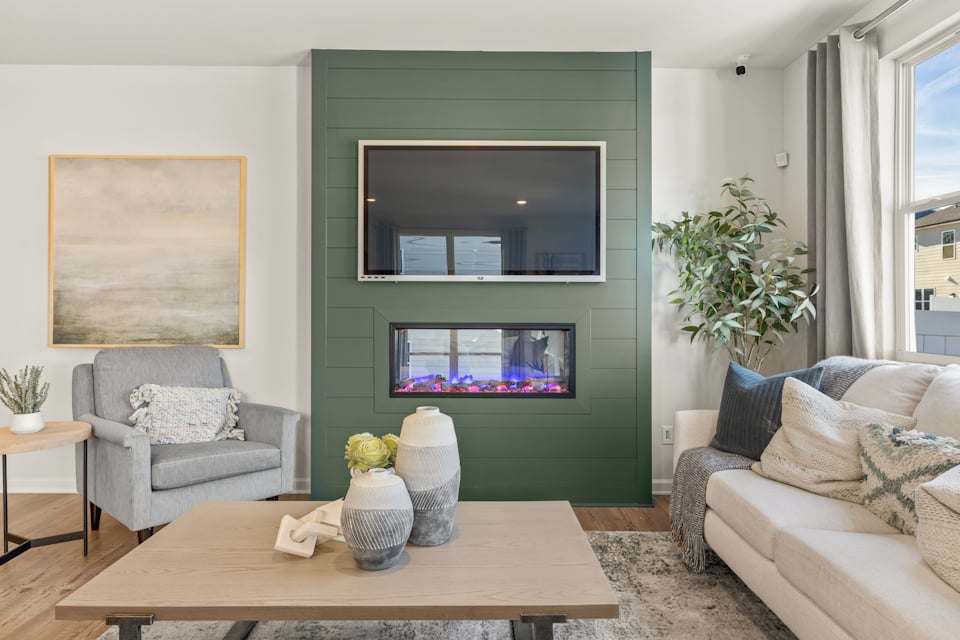 A living room with a green wall.