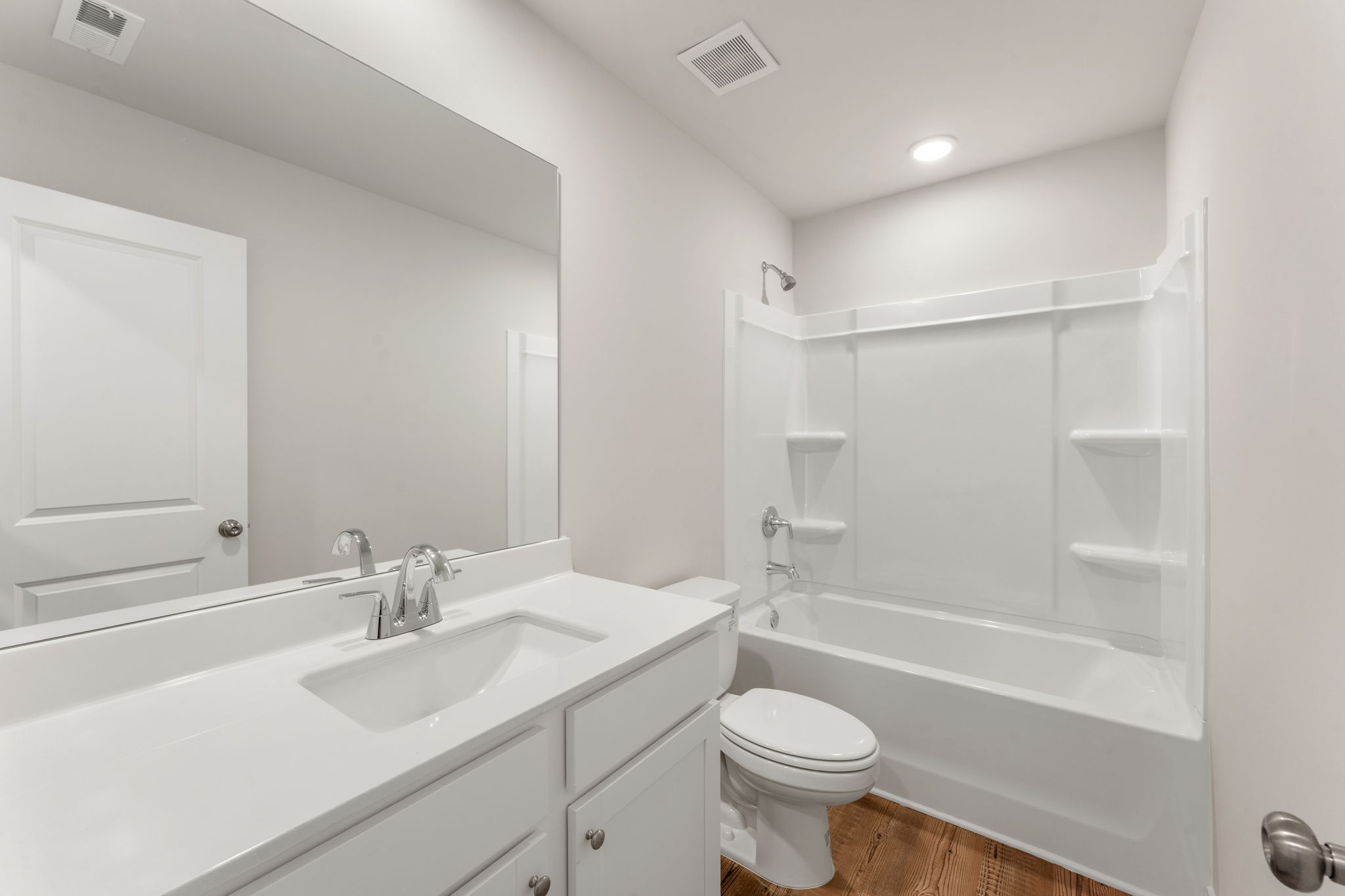 A bathroom with a tub sink and toilet.