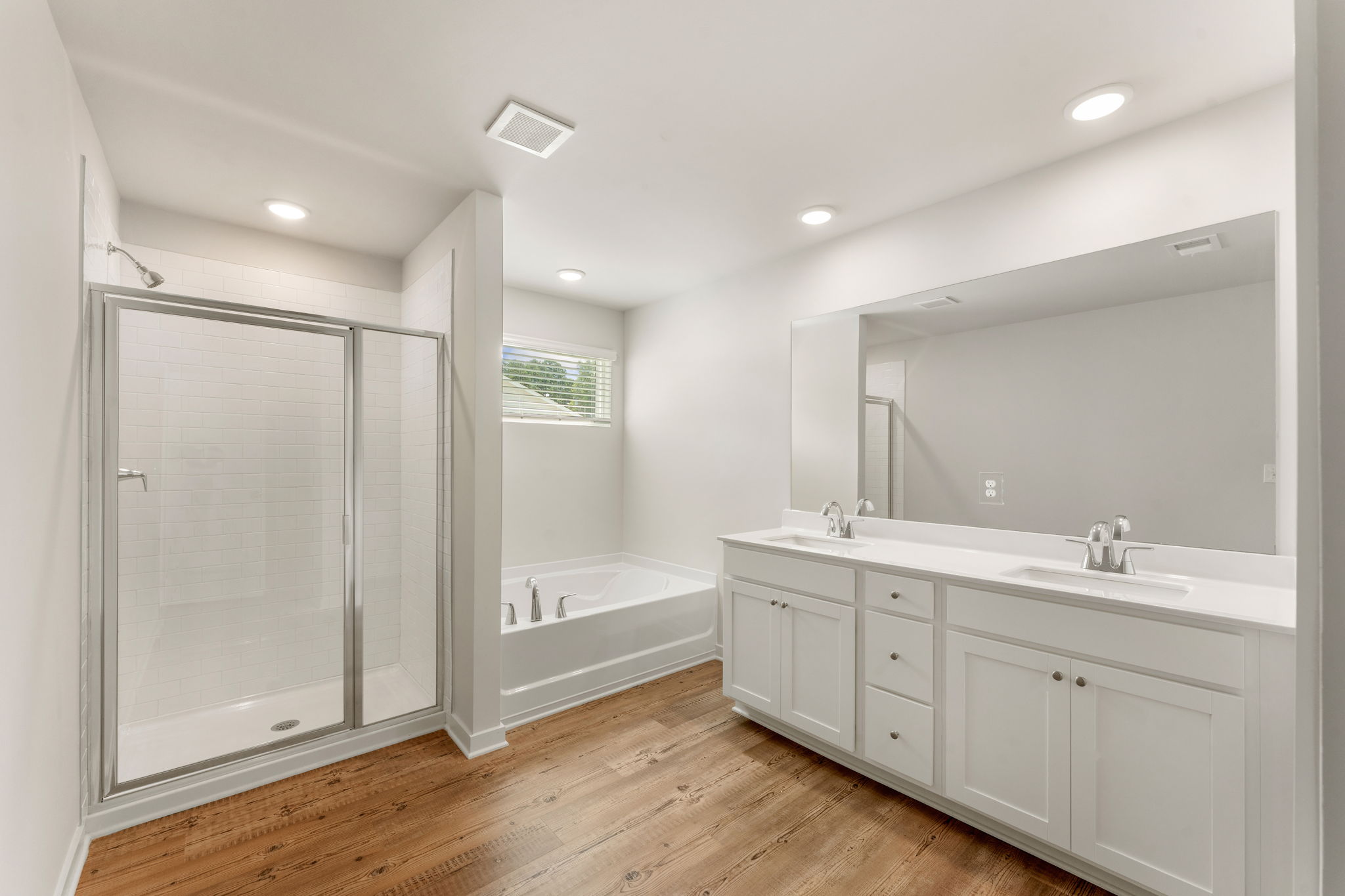 A bathroom with a tub sink and a shower.