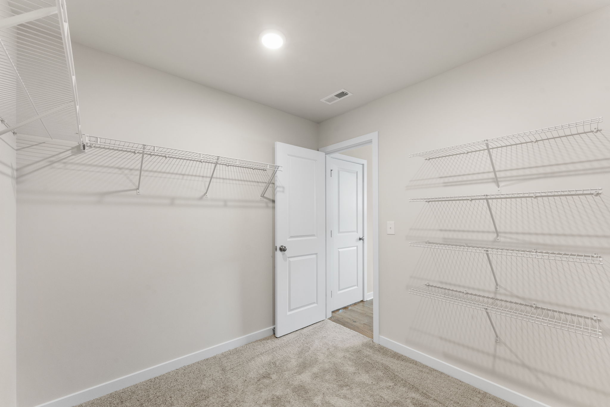 A room with white walls and a metal railing.